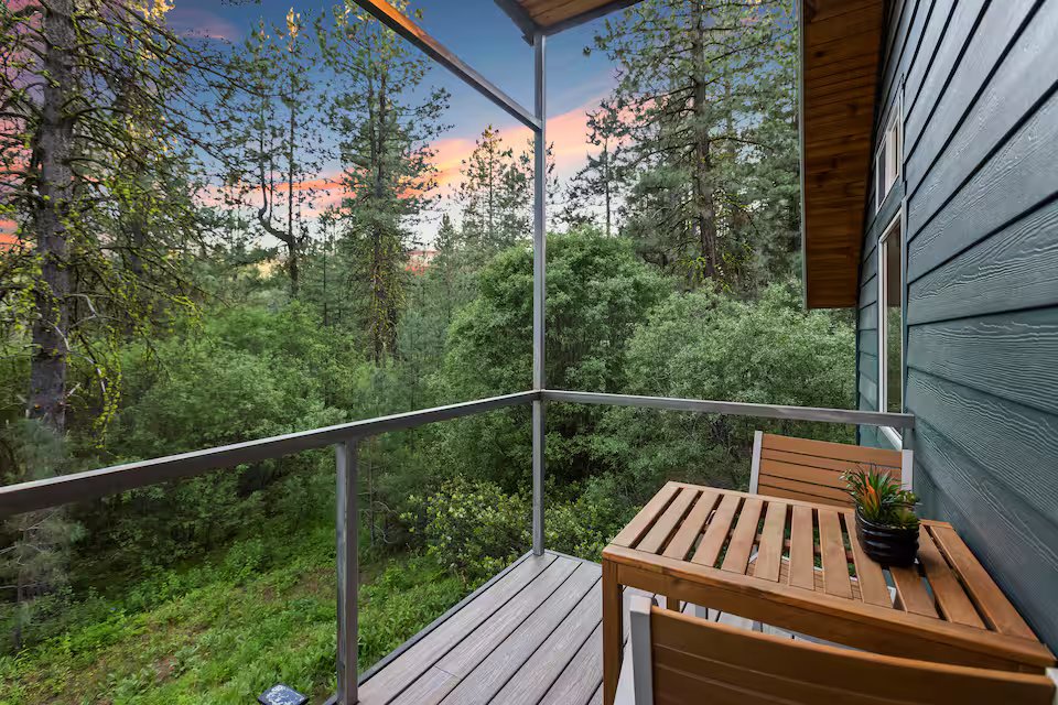 Balcony with teak table overlooking the pine forest