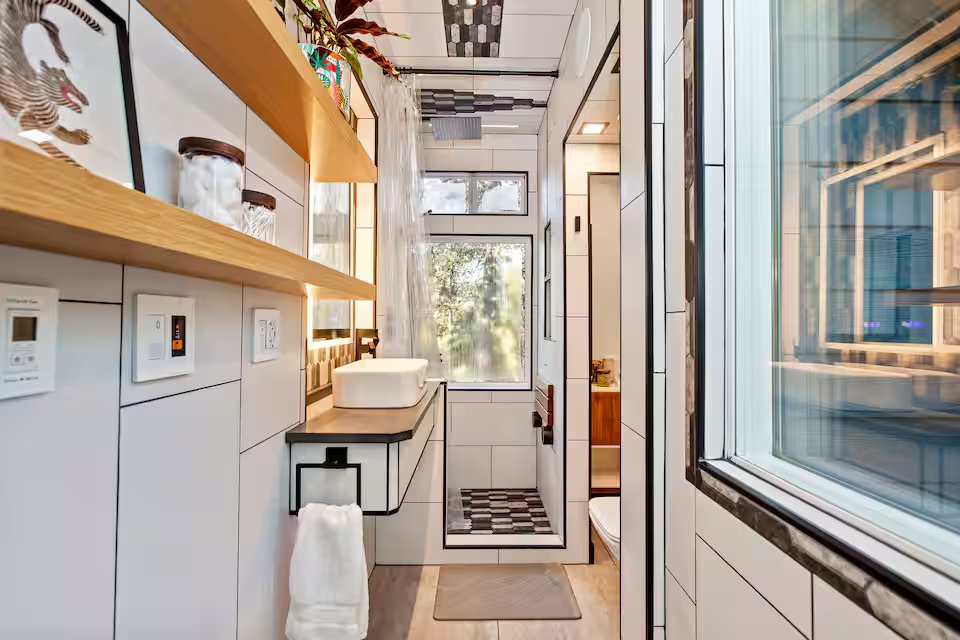 Bathroom with walk-in shower, vanity, and natural light