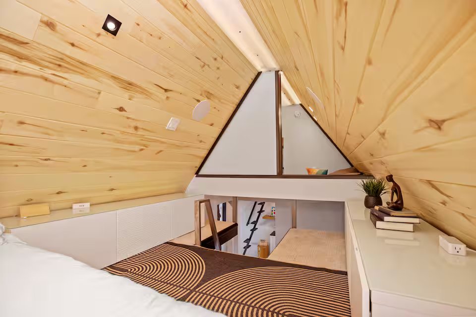 Bedroom loft looking down with built-in storage cabinets