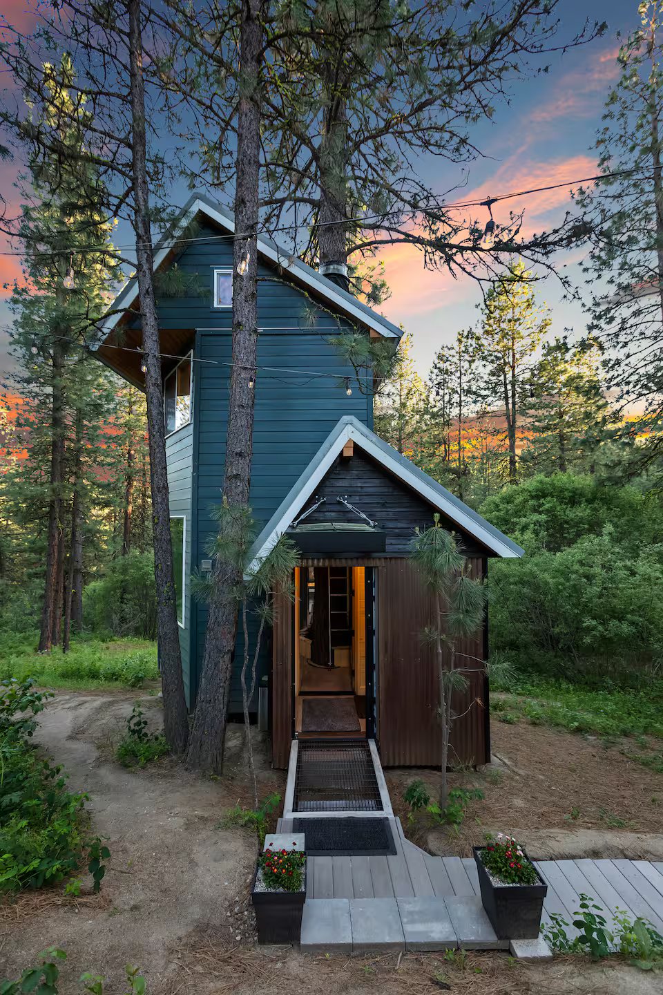 Banks Treehouse entrance at sunset, hand-crafted TinyHome nestled in Ponderosa pine forest