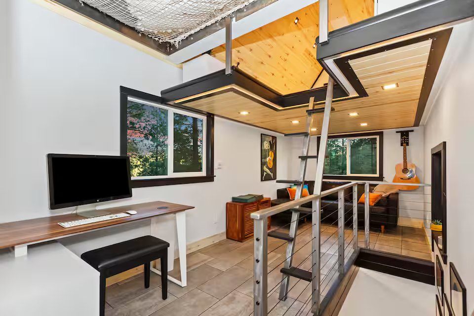 Mezzanine level with TV, desk area, and net loft above